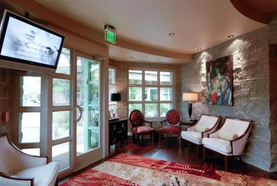 A beautiful, warm office interior shot of the waiting room from another angle showing the comfortable seating